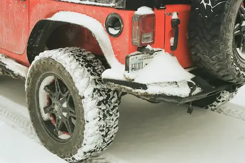 red jeep wrangler with big tires