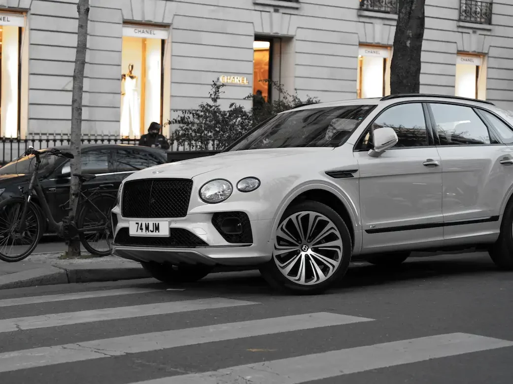 white Bentley Bentayga parked on the street