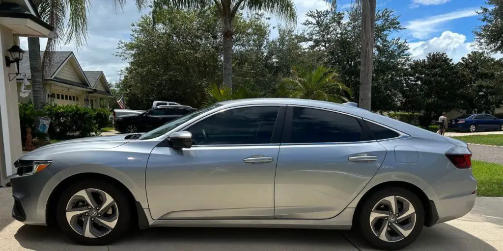 2021 silver Honda Insight parked in the driveway, side view